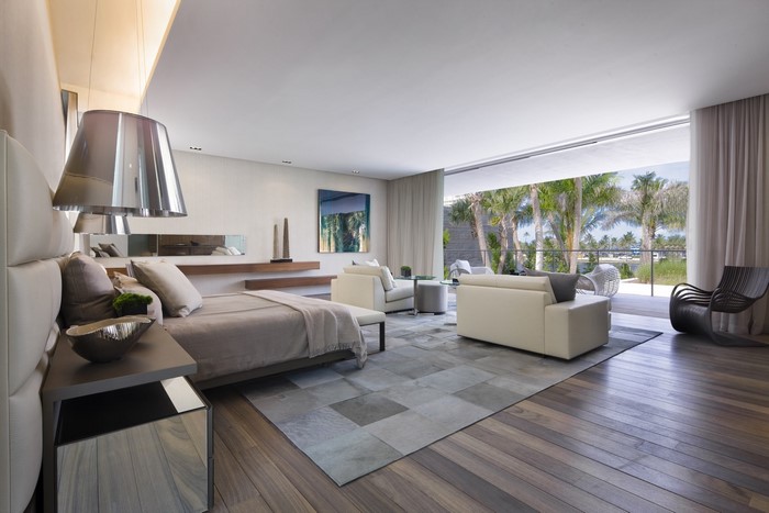 Modern bedroom with large windows and tropical view