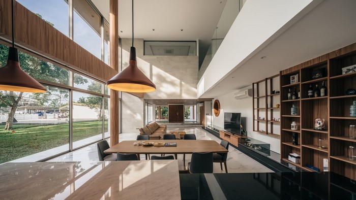 Modern living room with large windows and wooden shelves