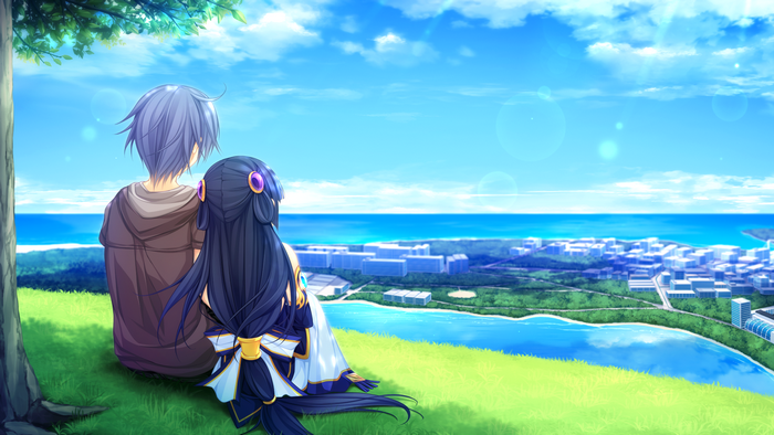 Couple sitting on a hill overlooking a city by the sea
