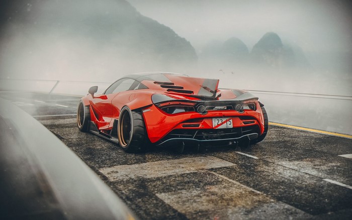 Red McLaren 720S on a foggy road