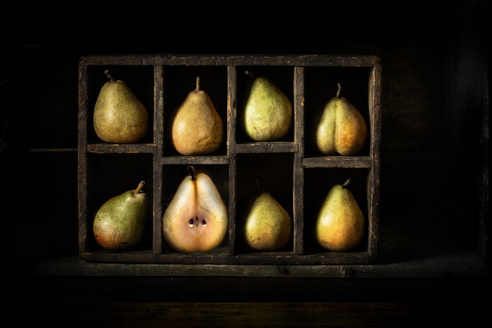 Still life of pears in a wooden crate