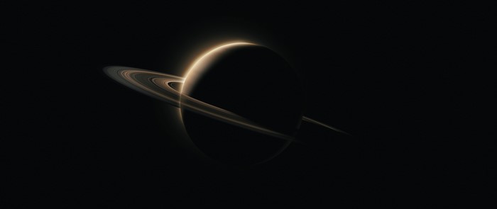 Saturn with rings in dark space