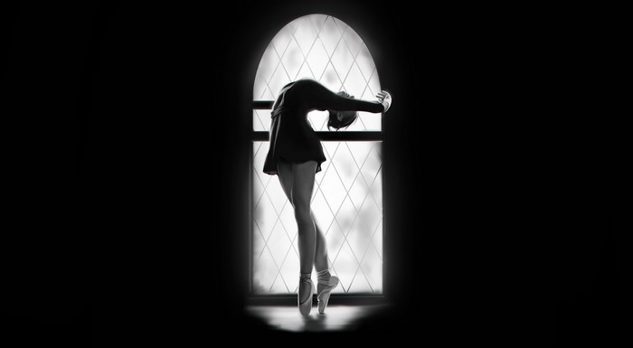 Ballerina in silhouette against a diamond-patterned window