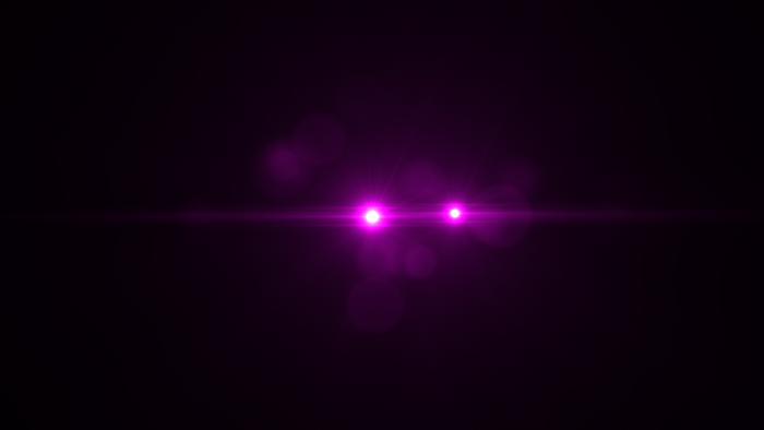 Purple lens flares and bokeh on black background