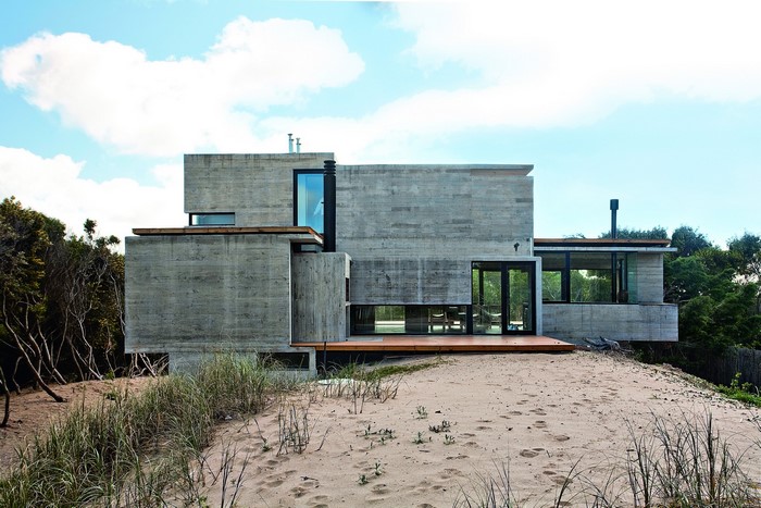 Modern concrete house on a sandy dune