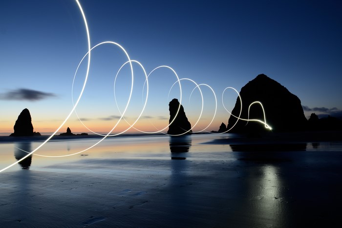 Light painting on a beach at dusk