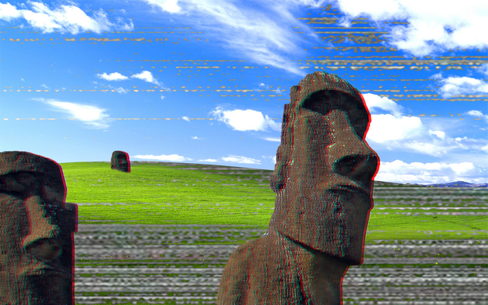Moai statues on a green hill with Windows XP background