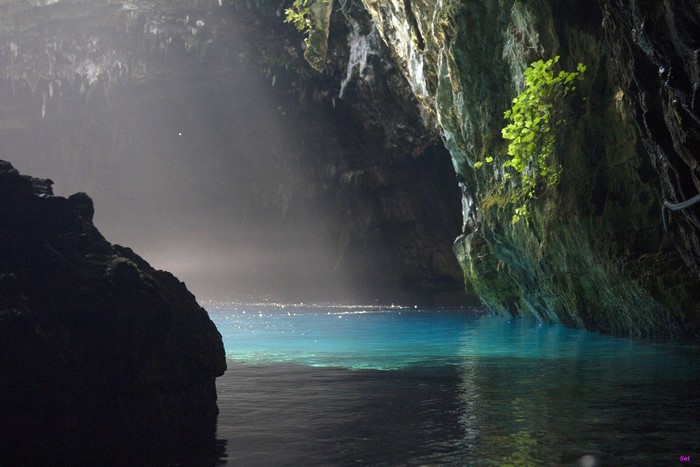 Cave with blue water and sunlight