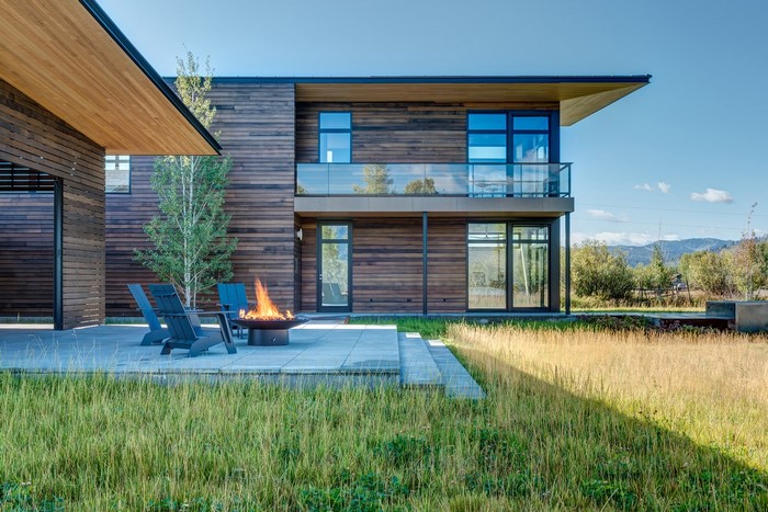 Modern house with outdoor fire pit and chairs