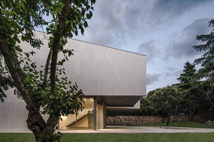 Modern house with trees and cloudy sky