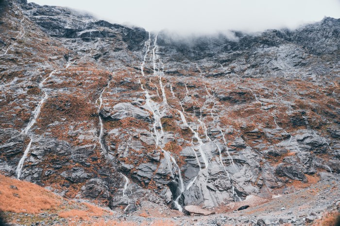 Waterfalls cascading down a rocky mountain in New Zealand