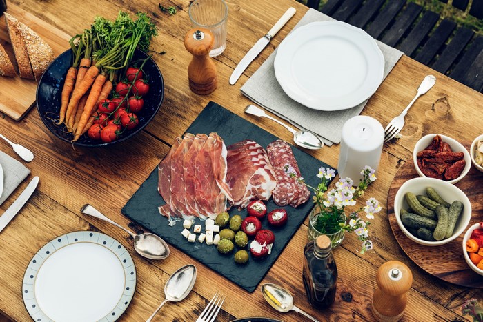 Charcuterie board with meat, vegetables, and bread