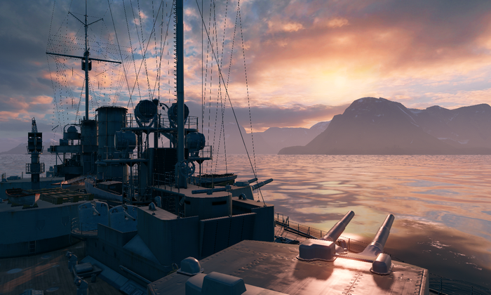 Warships in a calm sea at sunset