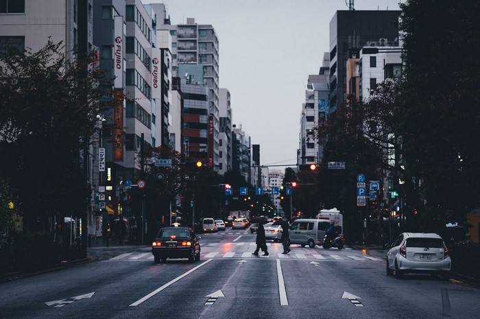 Street scene in Japan with cars and buildings