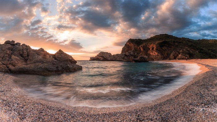 Sunset over a rocky bay in Pelion, Greece