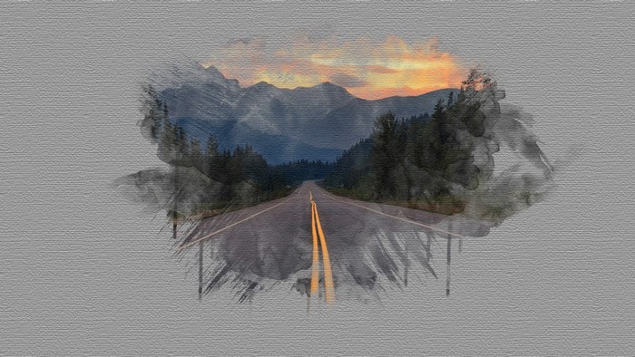 Road through mountains at sunset