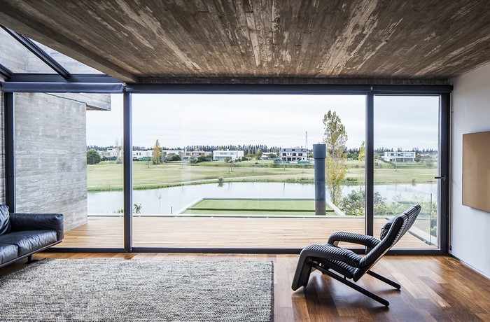 Modern living room with large windows overlooking a lake