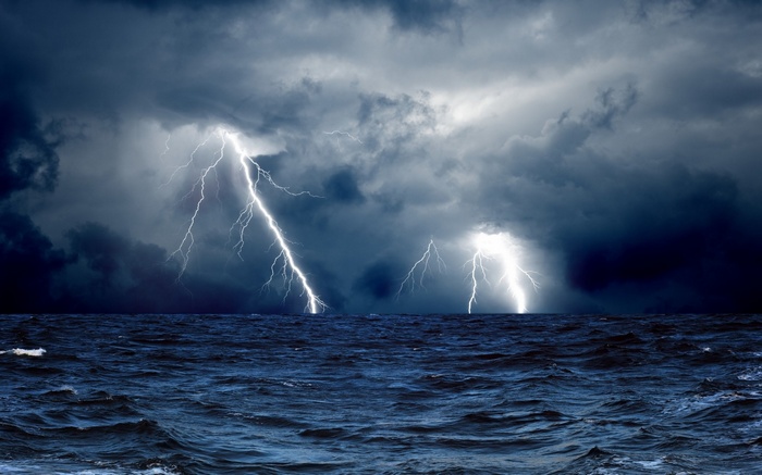 Lightning strikes over a stormy ocean