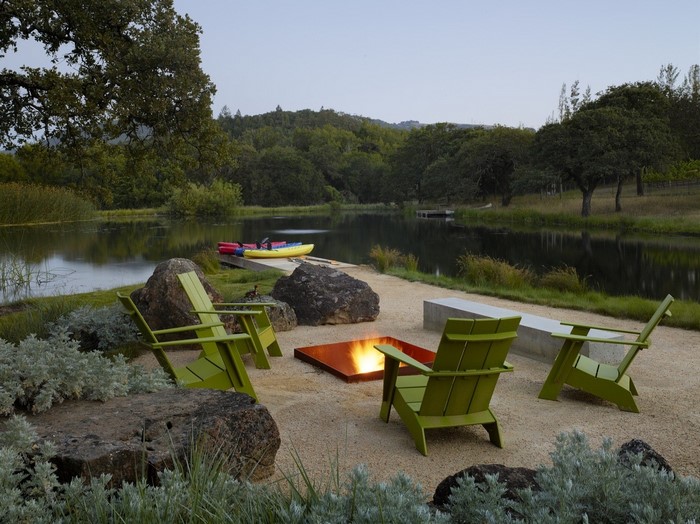 Outdoor seating area with fire pit by a lake