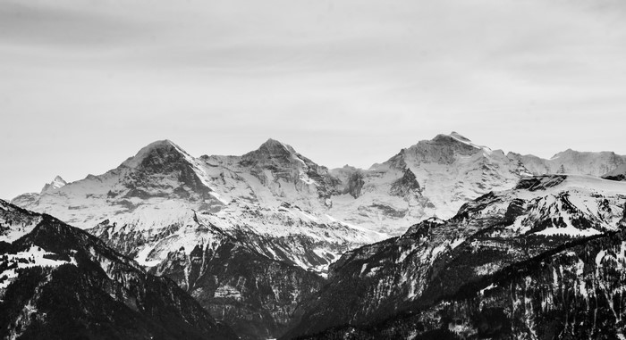 Snowy mountains under a cloudy sky
