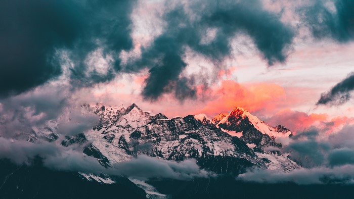 4K sunset over snow-capped mountains with clouds