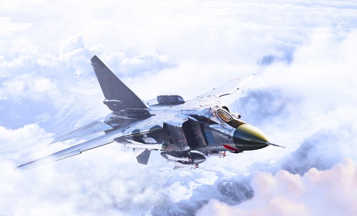 Military aircraft flying through clouds over mountains