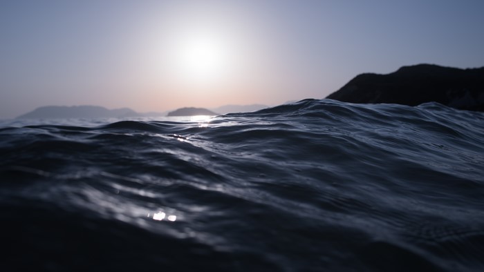 4K sea with ripples and waves at sunset
