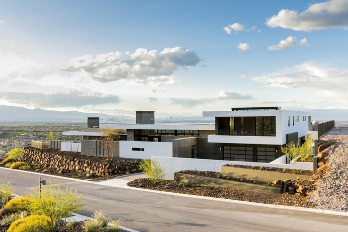 Modern mansion on a hill overlooking a city