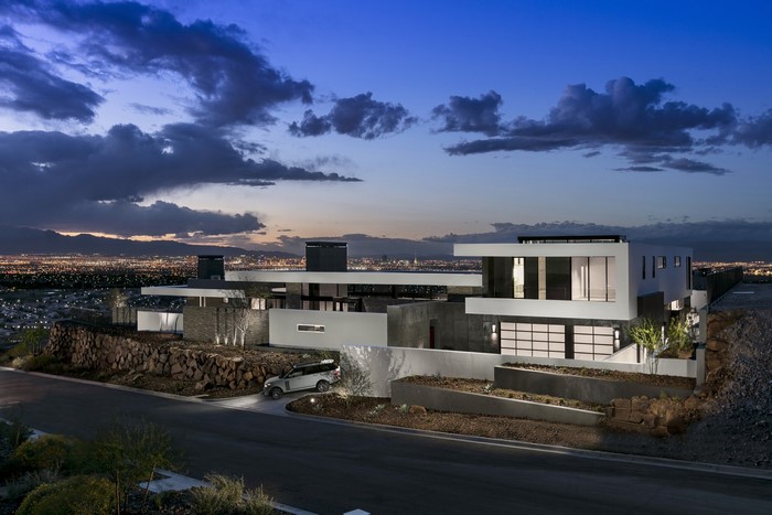 Modern luxury mansion with city view and Range Rover