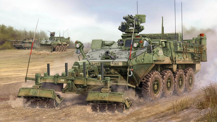 Military vehicle with mine plow and tanks in background