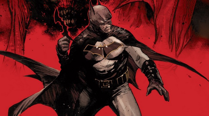 Batman holding a weapon against a red background