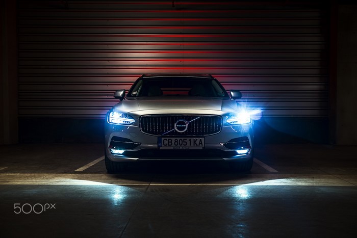 Volvo V90 CC parked in a garage with headlights on
