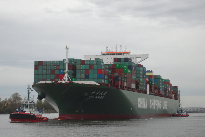 Container ship SCL MARS with tugboats