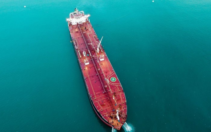 Aerial view of a large red oil tanker at sea