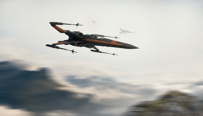 Star Wars X-wing fighter flying over mountains