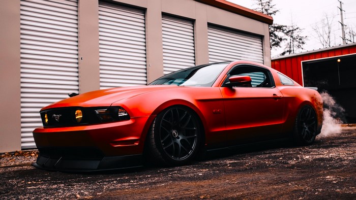 Red Ford Mustang Boss 302 with smoke