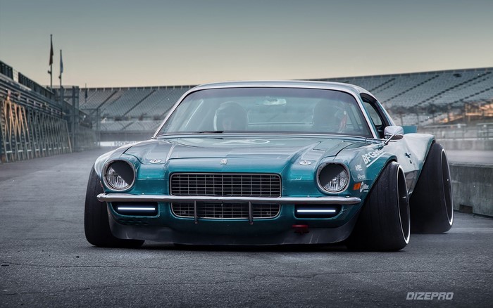 Modified teal 1970s Chevrolet Camaro on a racetrack