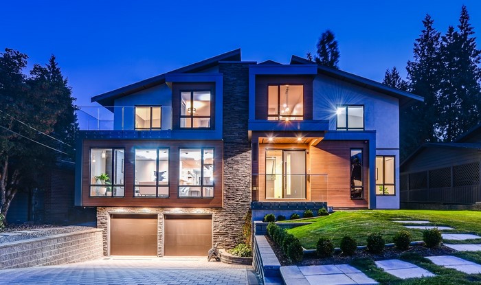 Modern luxury house with garage and manicured lawn
