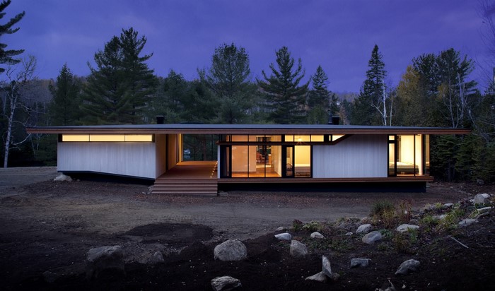Modern house in a forest at dusk