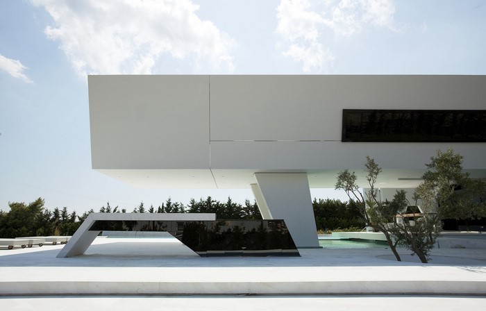 Modern white house with geometric elements and trees