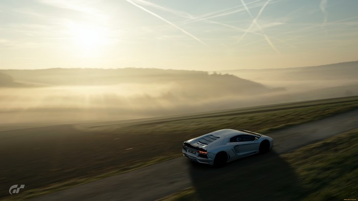 White Lamborghini Aventador driving on a road at sunrise