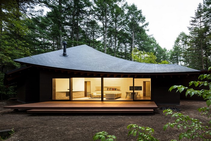 Modern house with curved roof in a forest