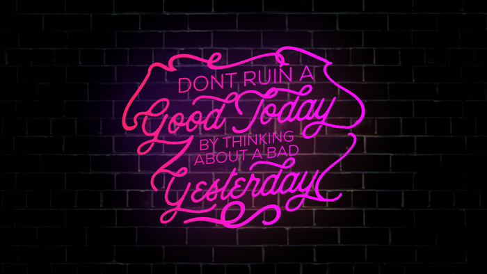 Neon quote on a brick wall