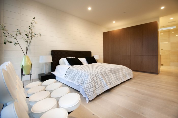 Modern bedroom with large wardrobe and seating area