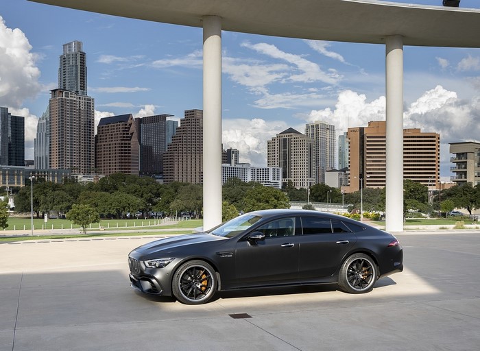 Mercedes-AMG GT 4-door parked in a city with skyscrapers