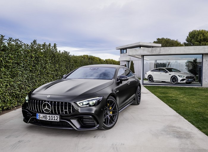 Mercedes-AMG GT 4-door cars in modern driveway