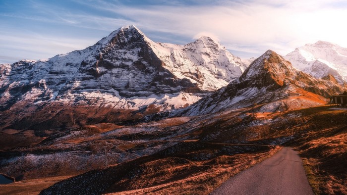 Road leading to snowy mountains in Switzerland