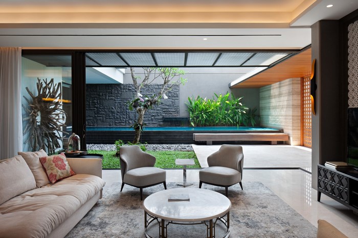 Modern living room with indoor swimming pool and garden