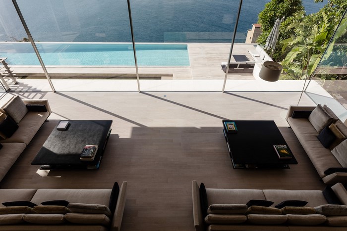 Modern living room with swimming pool and ocean view