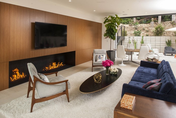 Modern living room with fireplace and blue sofa
